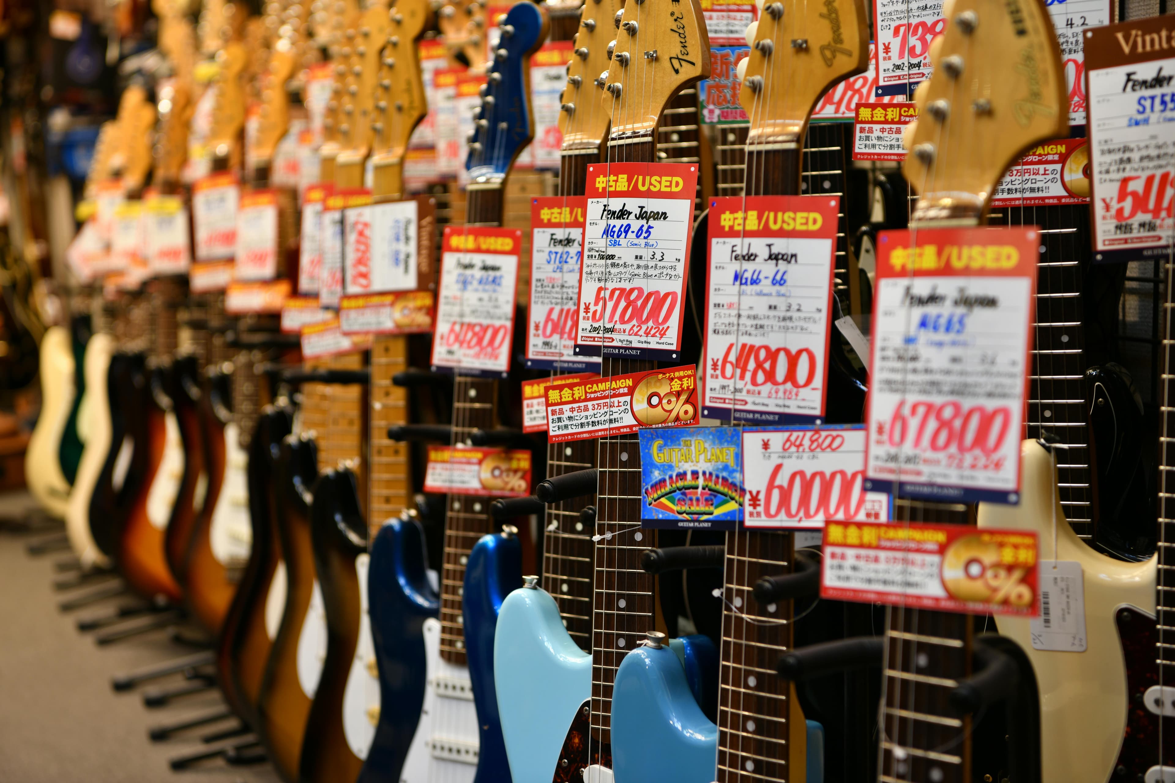 Shopify store owner analyzing product pricing on a laptop with price tags