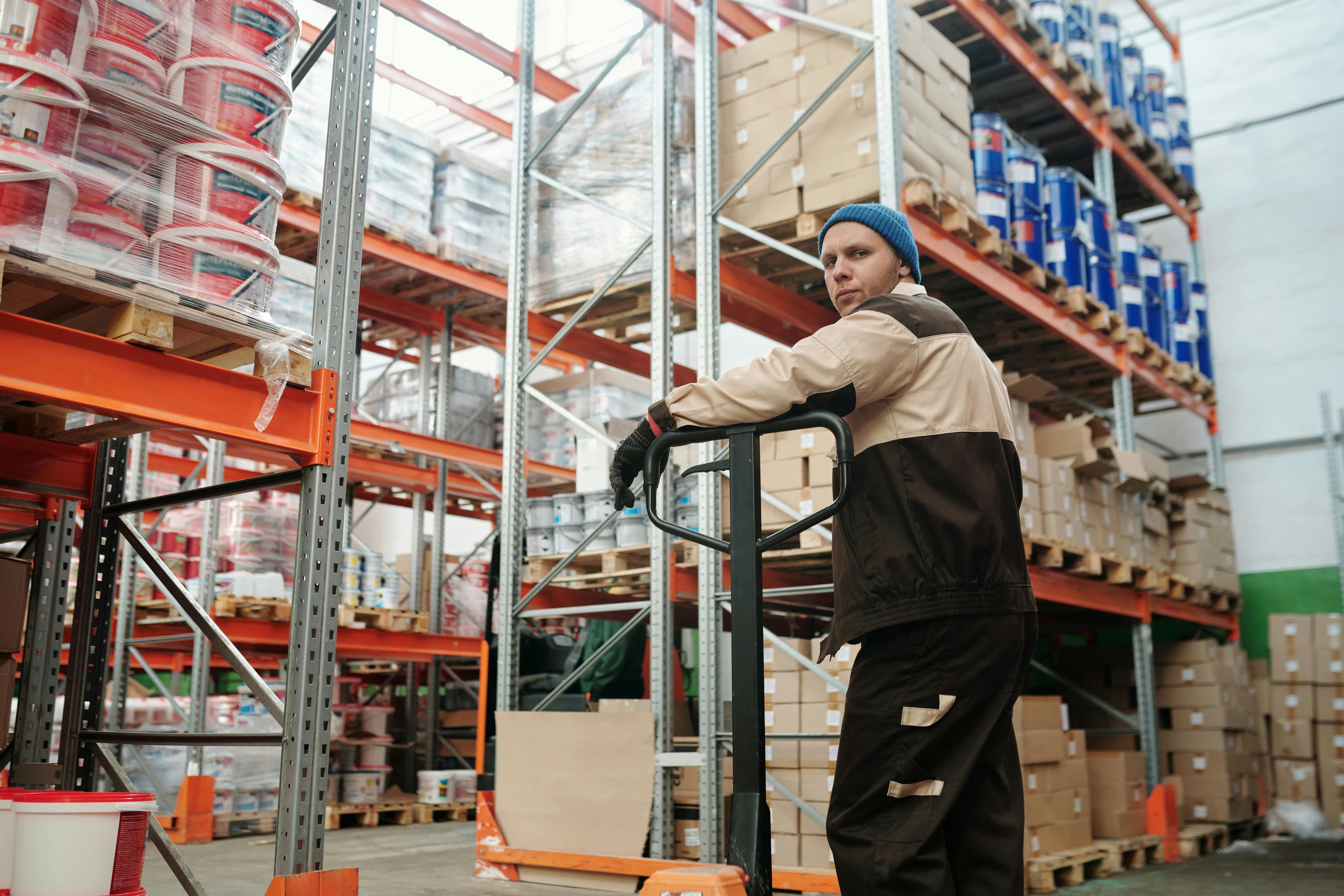 Warehouse inventory with spreadsheet overlay showing cost of goods sold calculations